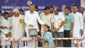 रमन सिंह लैपटॉप बांटते हुए